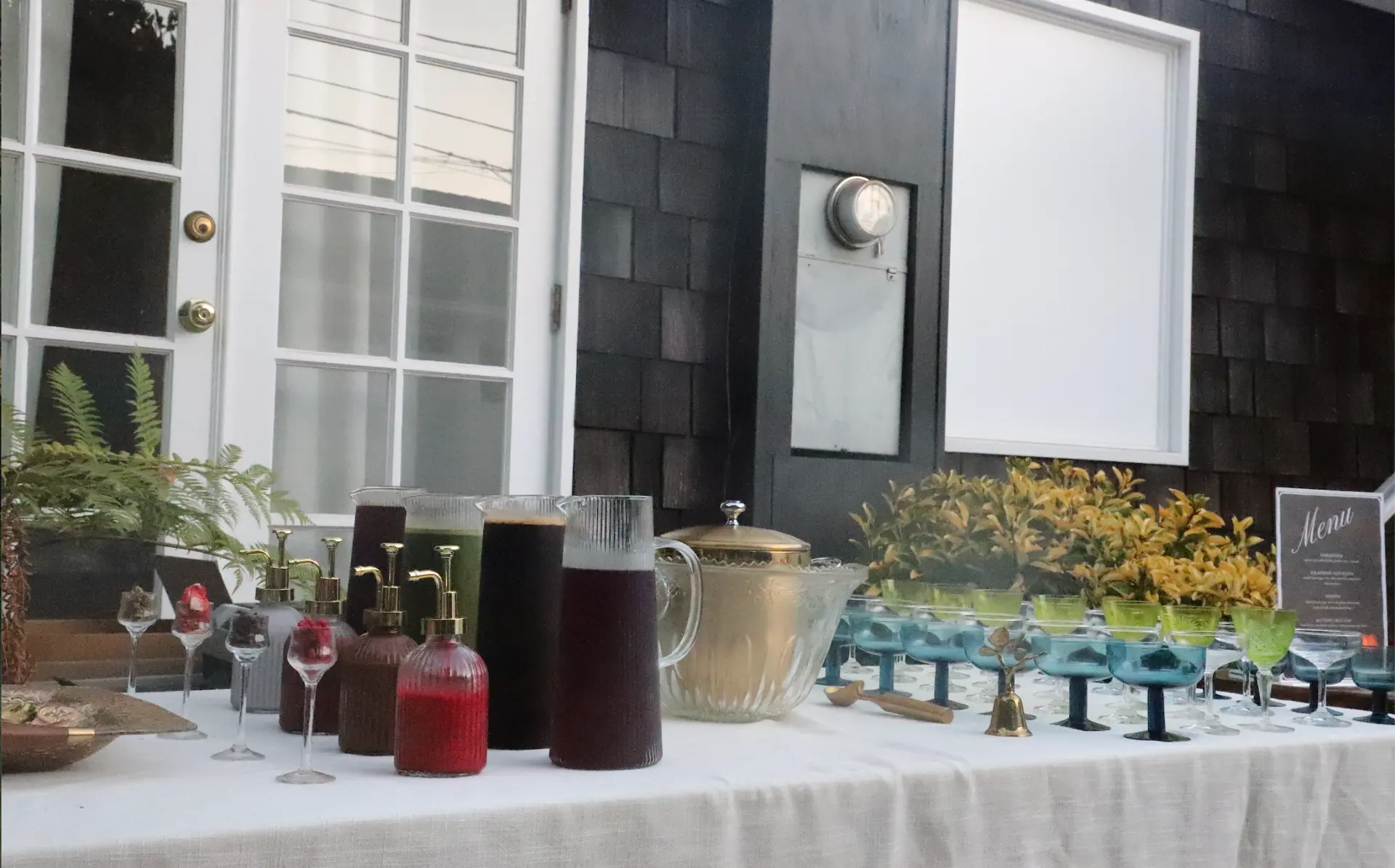 A fully set Fogato service table with coupes, pitchers, and a gold ice bowl at a private event