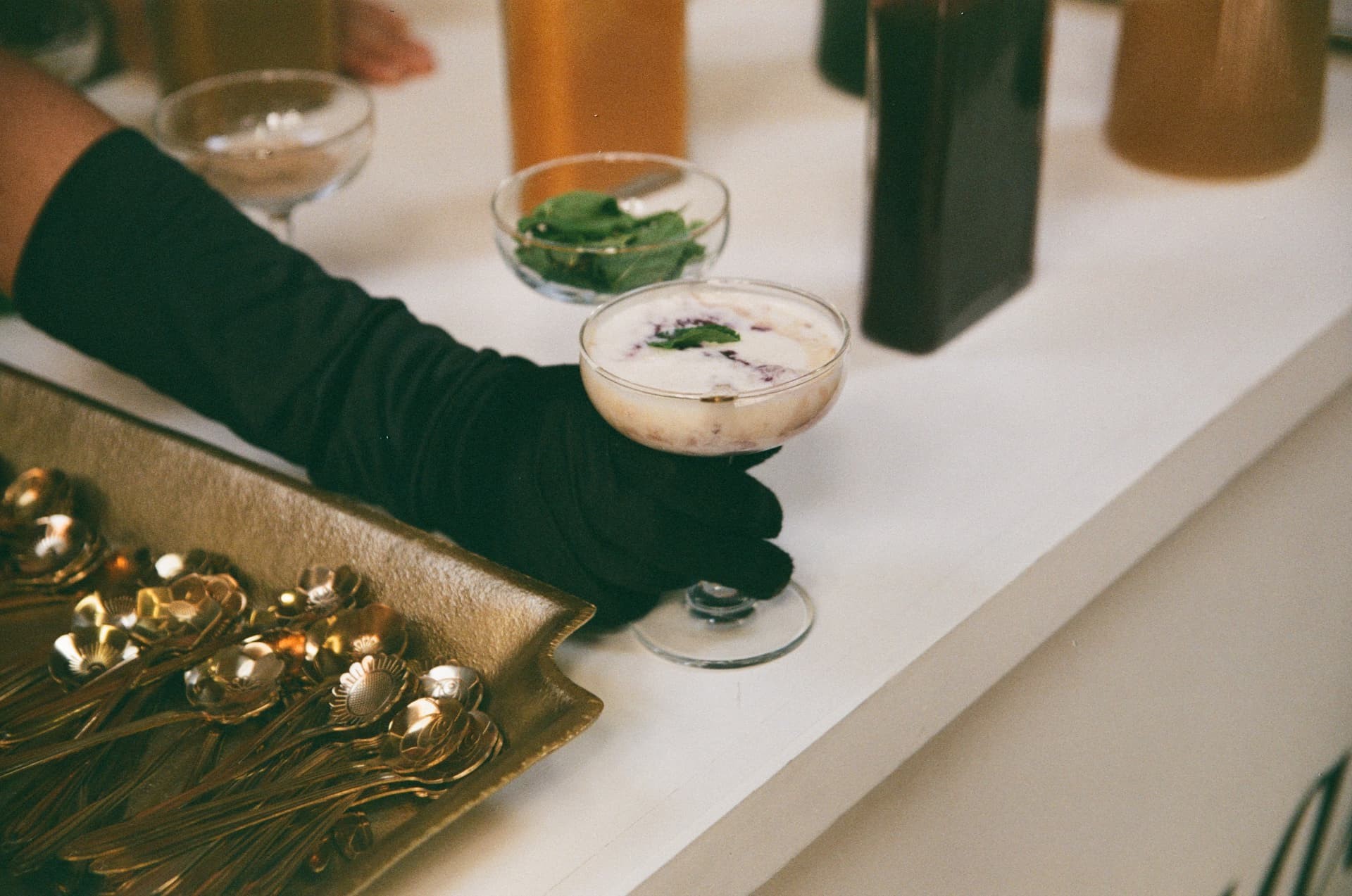 A gloved hand serving a Fogato coupe